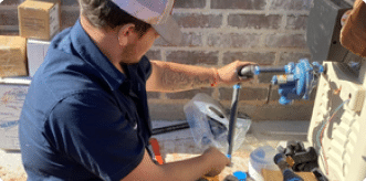 Licensed plumber inspecting a residential gas line