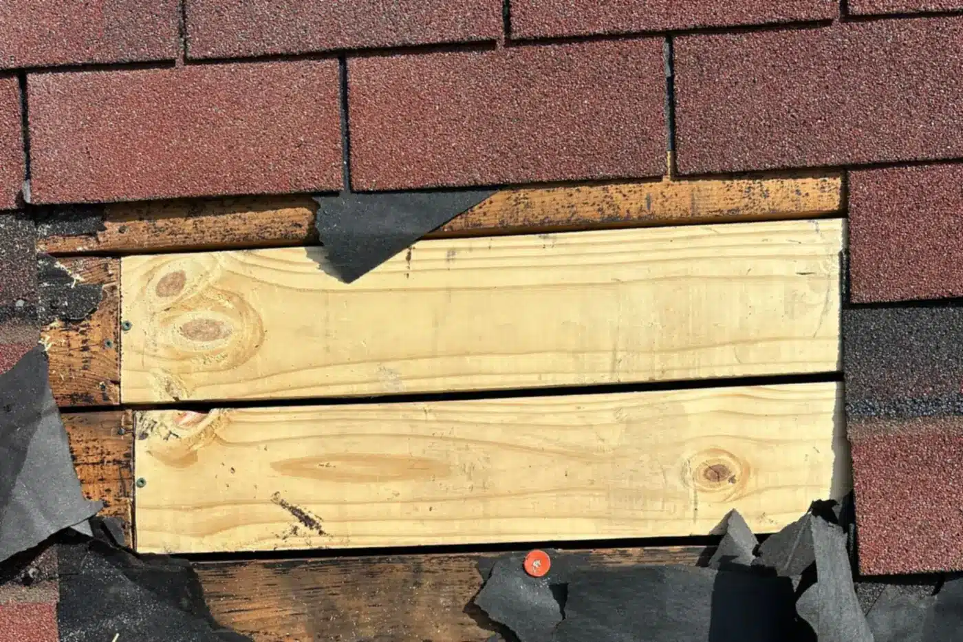 Roofer installing new plywood roof decking on a Shreveport home