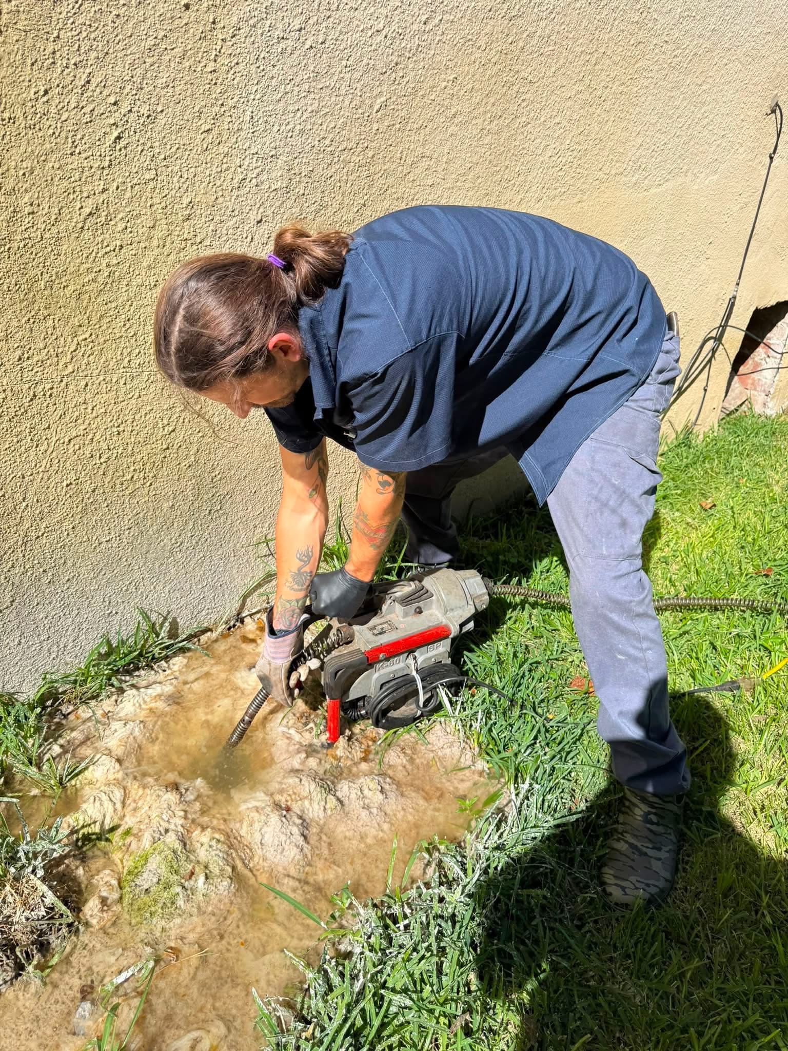 Blue Note Pros plumbing crew trenching along a Shreveport home to repair and protect water lines