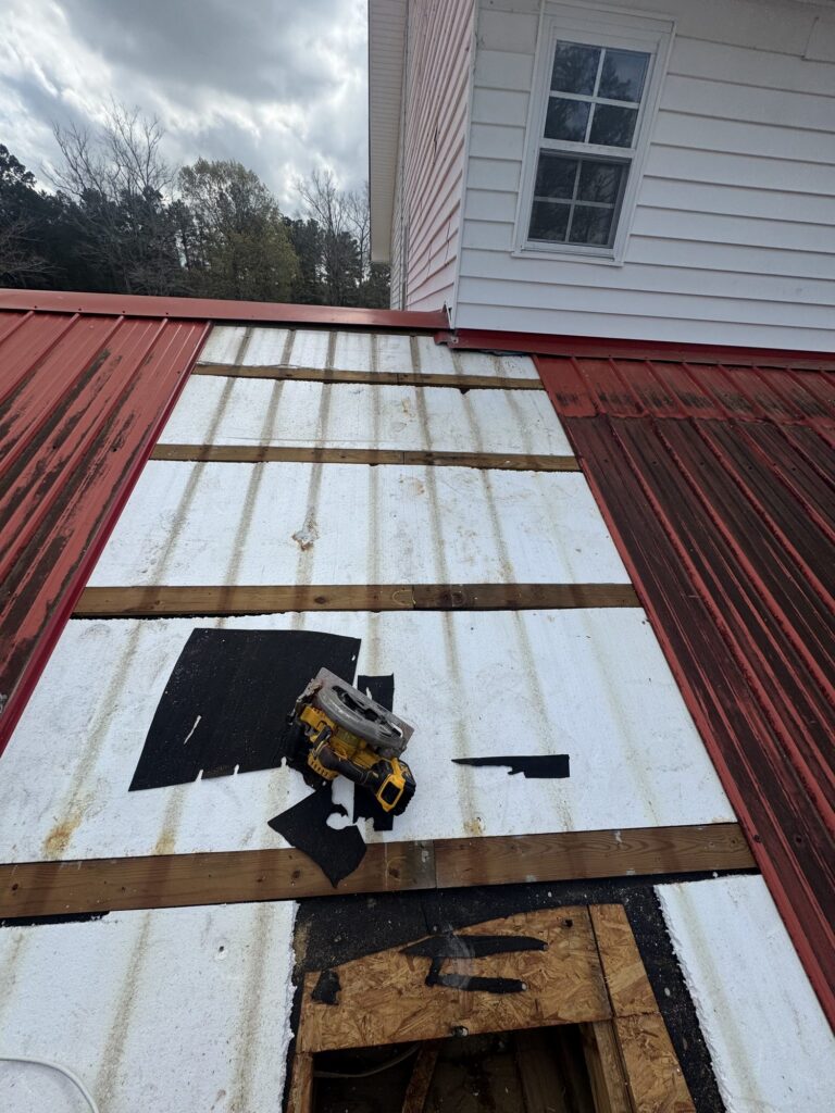 Blue Note Pros repairing a metal roof leak and damaged decking