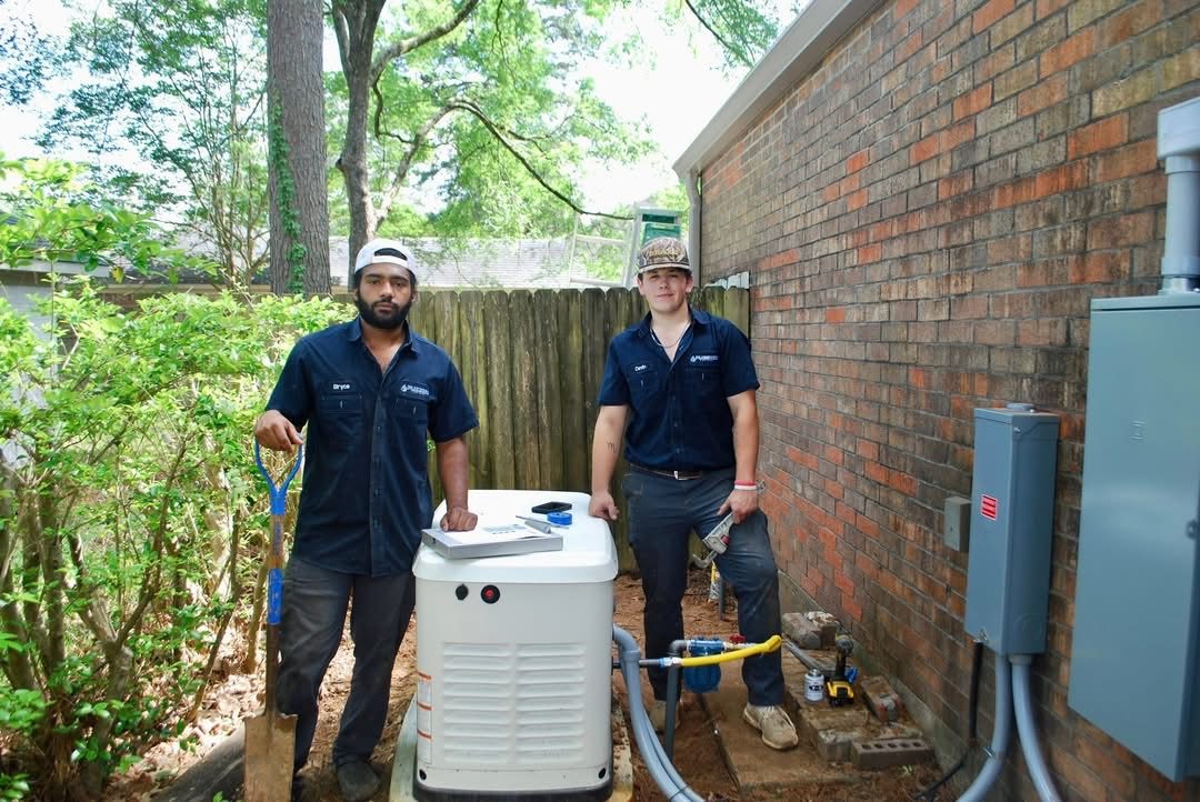 Blue Note Pros plumbers next to a newly installed home standby generator