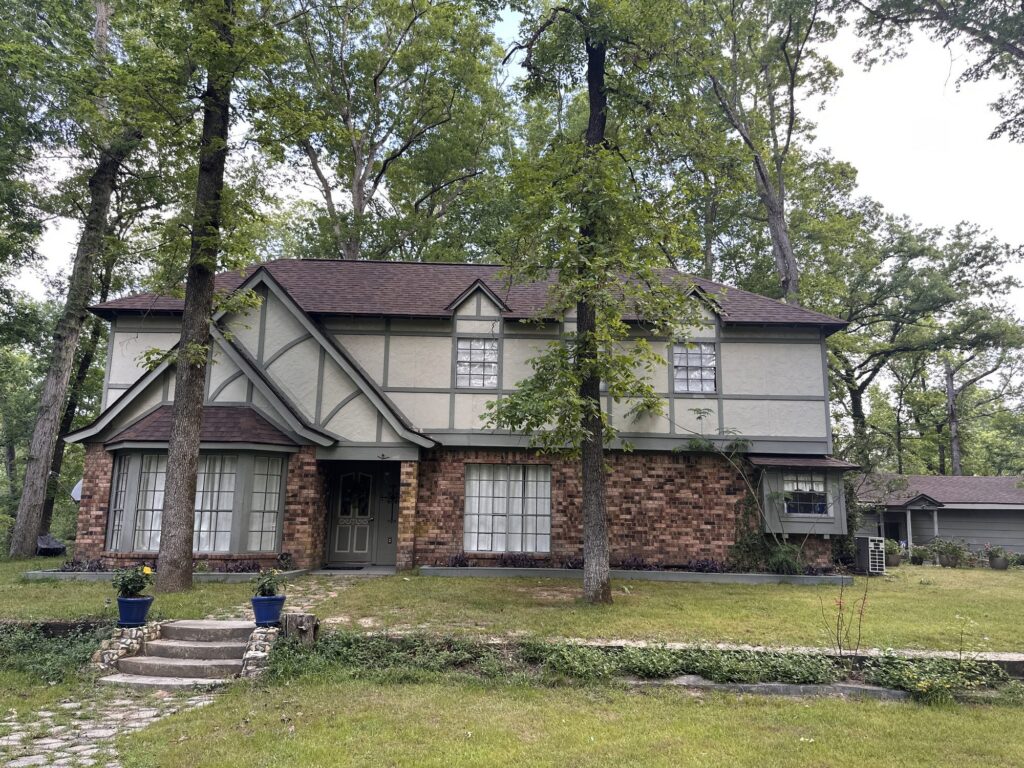 Tudor-style home with a new architectural shingle roof by Blue Note Pros